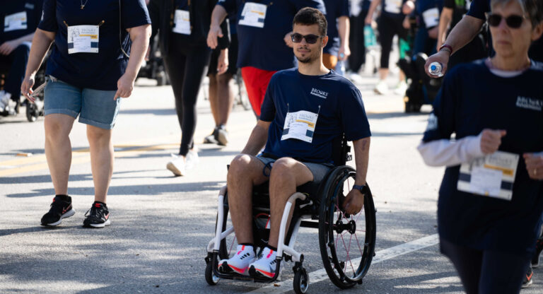 an adaptive sports participant taking part in a race event in his wheelchair