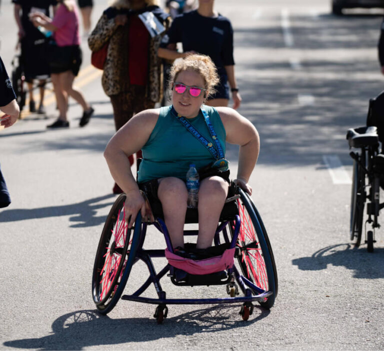 young woman in her wheelchair taking part in a race