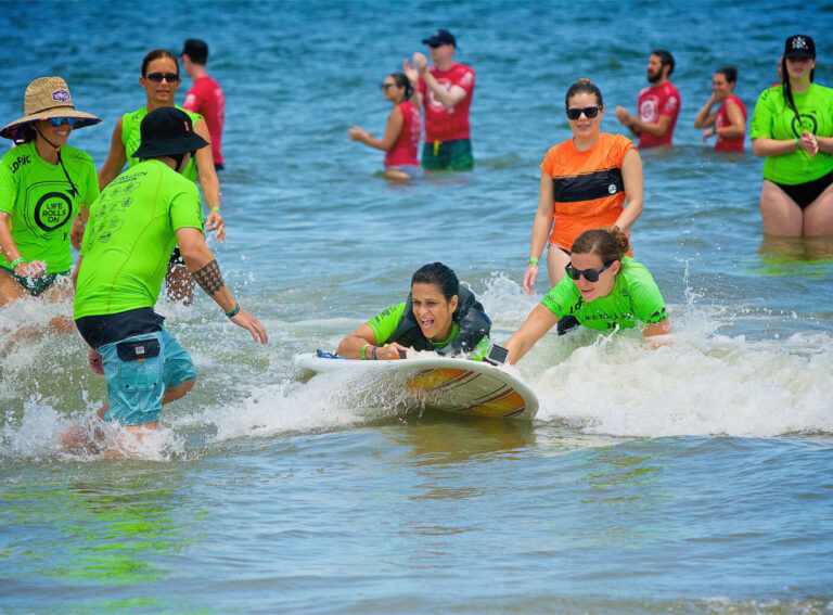 group of participants surfing together