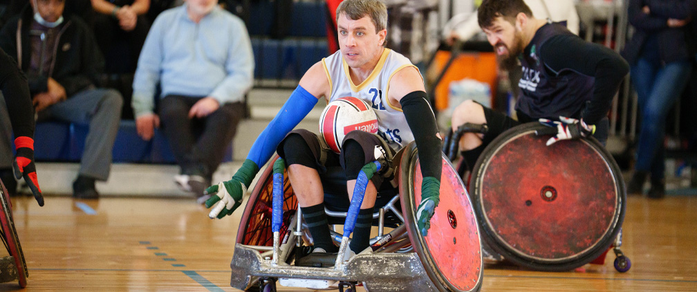 man playing wheelchair rugby on indoor court